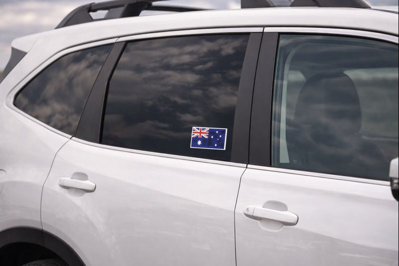 Car with an Australian flag sticker on a cloudy day