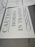 Decorative decal with 'Horses in Transit' and 'Caution' on a gray background