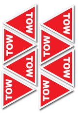 Red triangular tow signs with white text on a white background