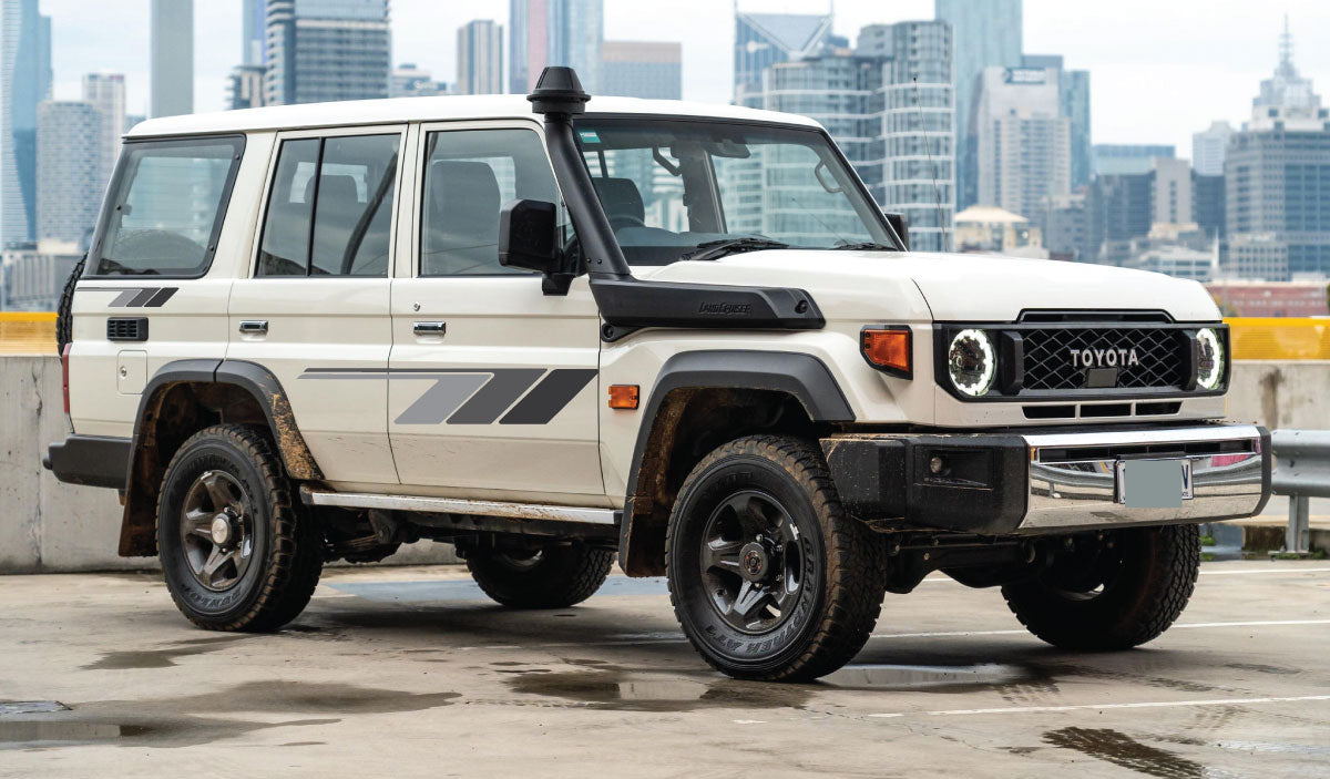 A Toyota Landcruiser with retro side body stripe stickers in beige, black, and orange colors.
