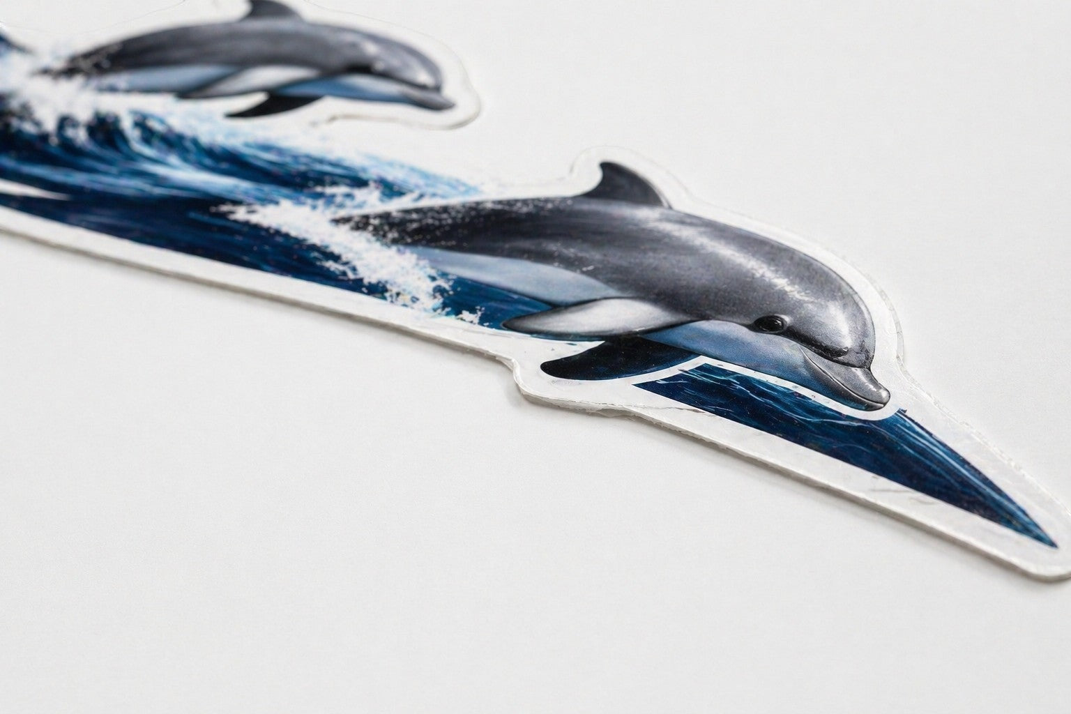 Mega Sticker Store dolphin and wave vinyl decal graphic for motorhomes and boats with a glossy protective finish.