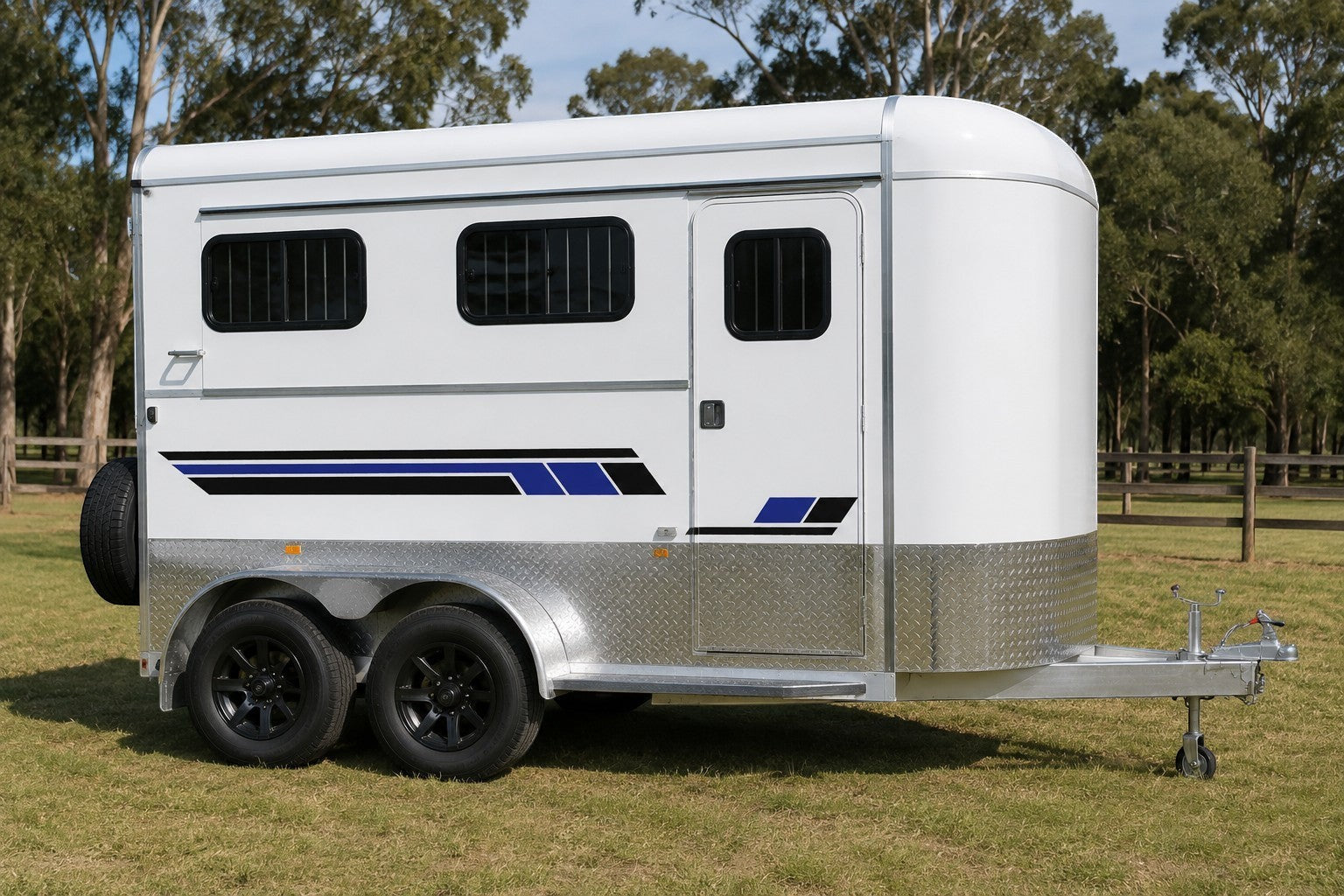 Mega Sticker Store horse float side stripe decals in blue and black vinyl applied to a white trailer exterior.