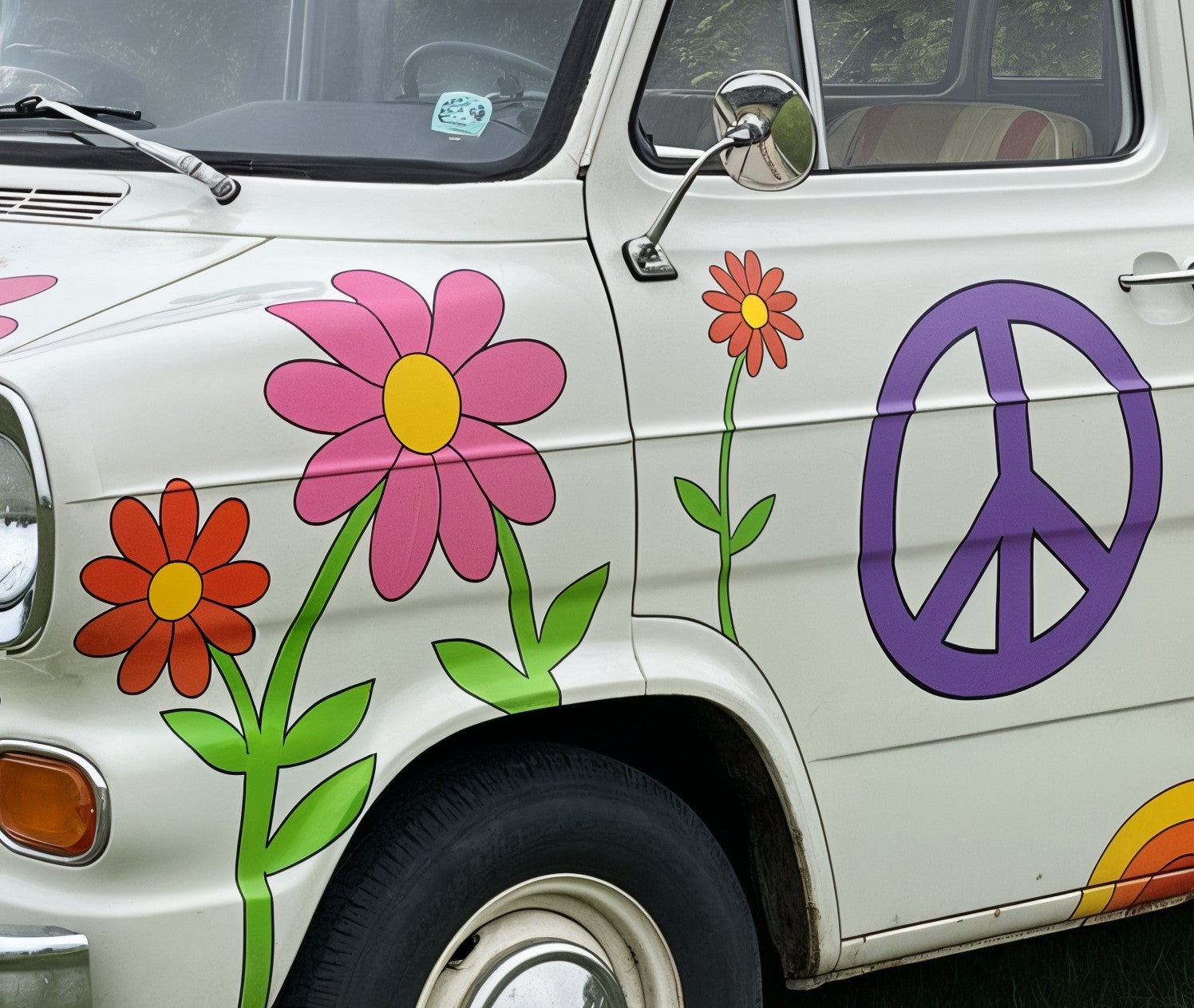 Mega Sticker Store retro flower and peace sign vinyl decals applied to the side of a white vintage camper van.