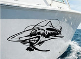 Mega Sticker Store large aggressive shark vinyl decal applied to the white hull of a fishing boat on the water.