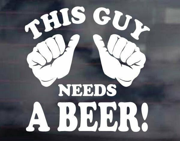 A sticker with the text 'This Guy Needs A Beer' in white, indicating a humorous message