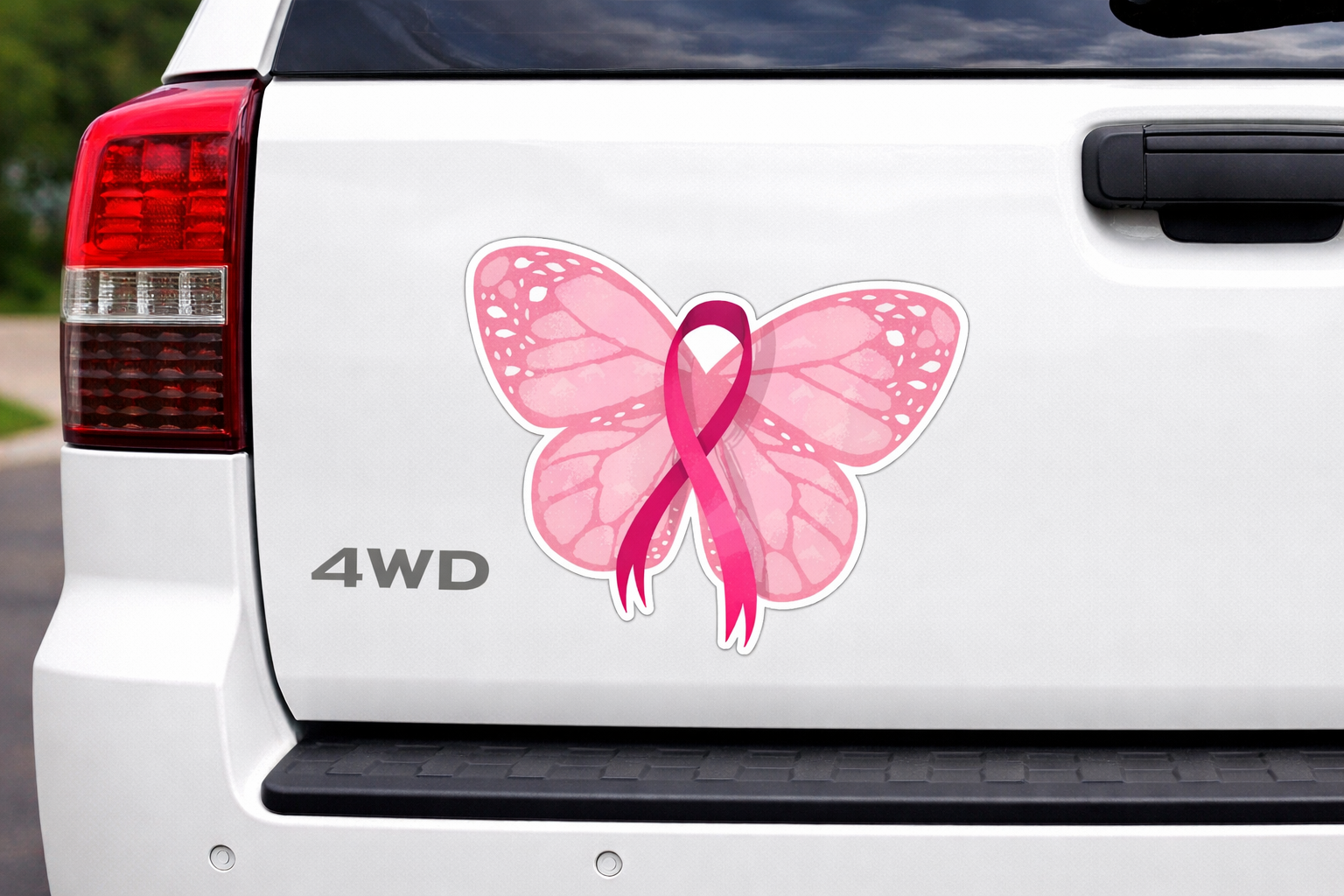 White car with a pink butterfly and breast cancer awareness ribbon decal on the back