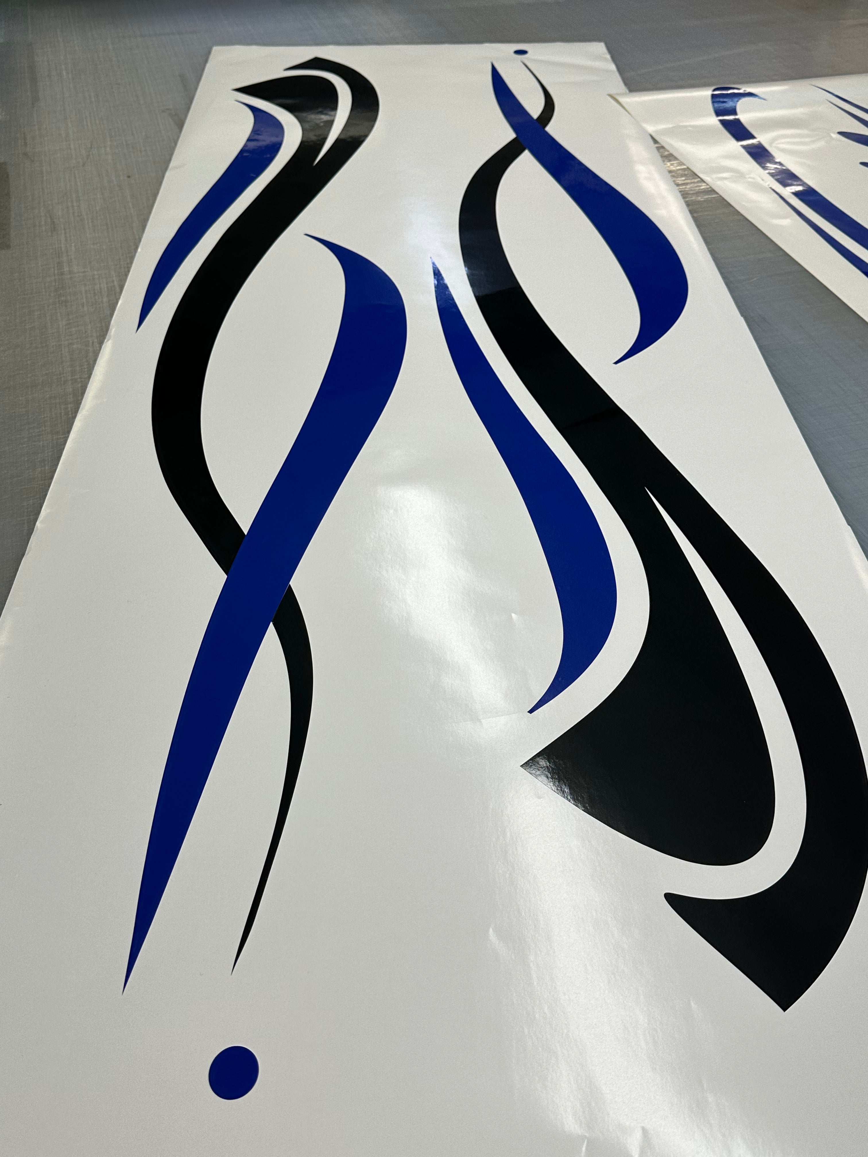 A set of stripe decals with a blue, black, and white design intended for use on vehicles such as motorhomes or boats.