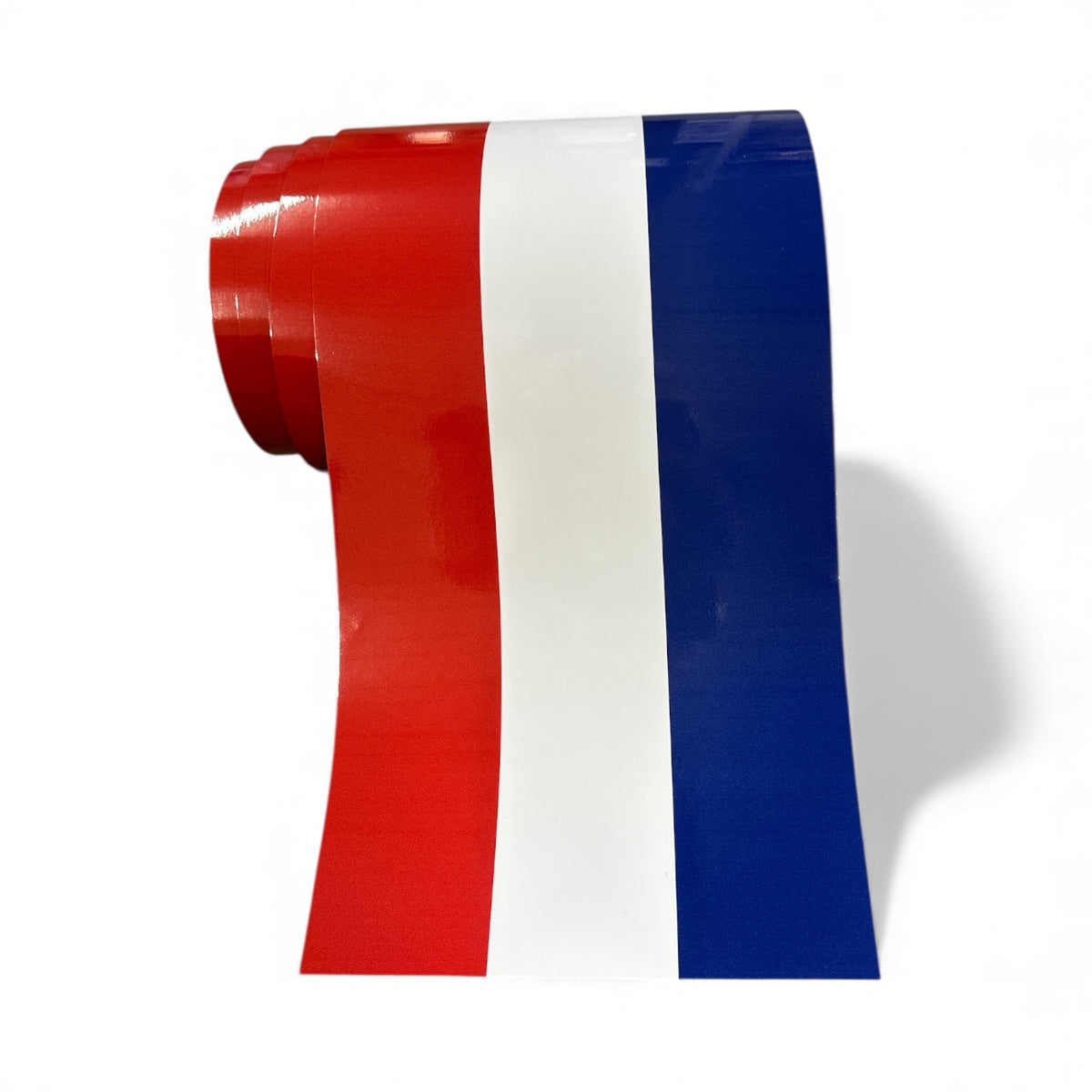 Roll of red, white, and blue tape on a white background