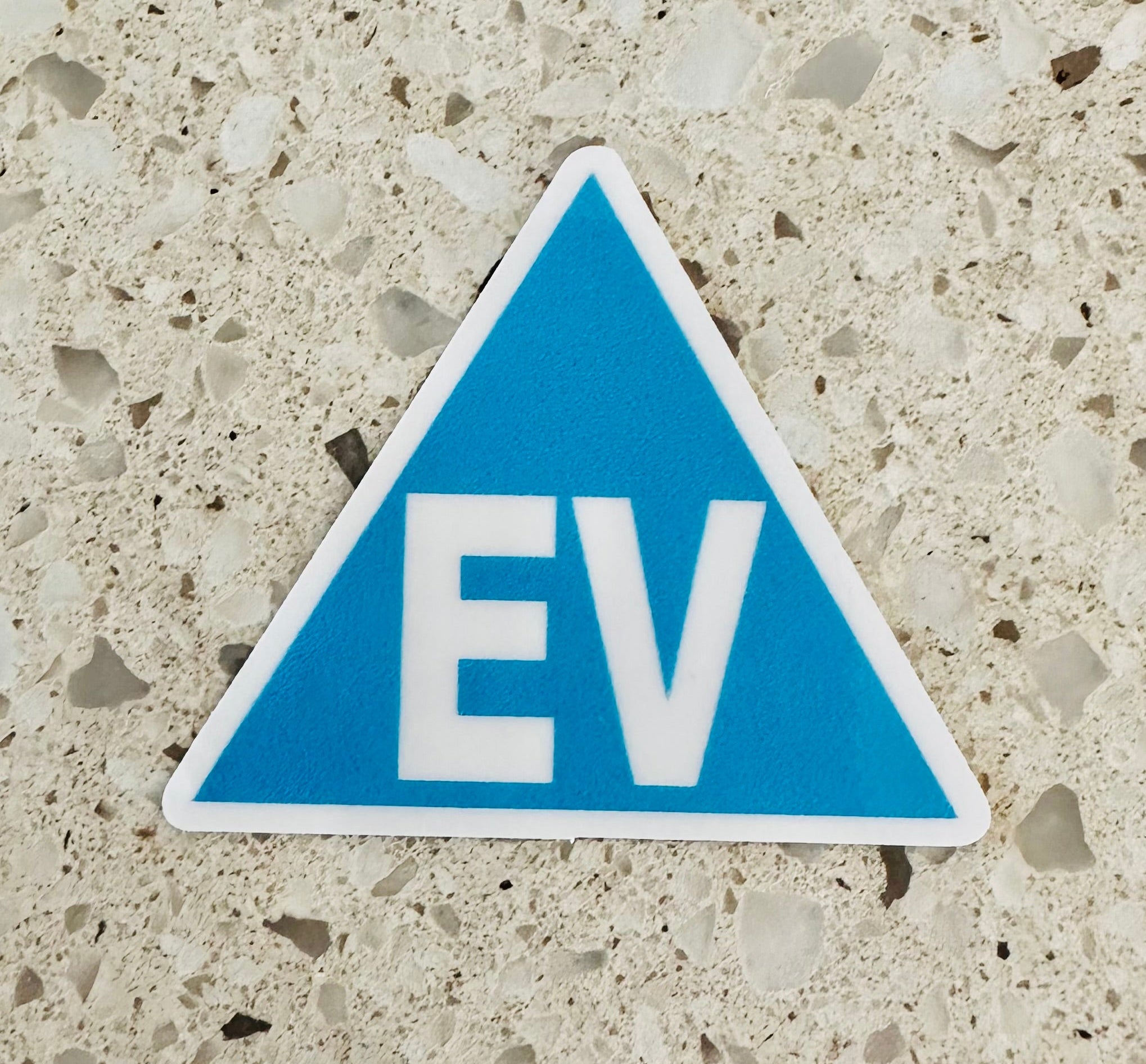 Electric vehicle EV identification sticker displayed beside a vehicle licence plate