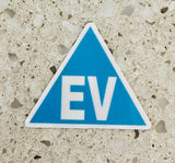Electric vehicle EV identification sticker displayed beside a vehicle licence plate