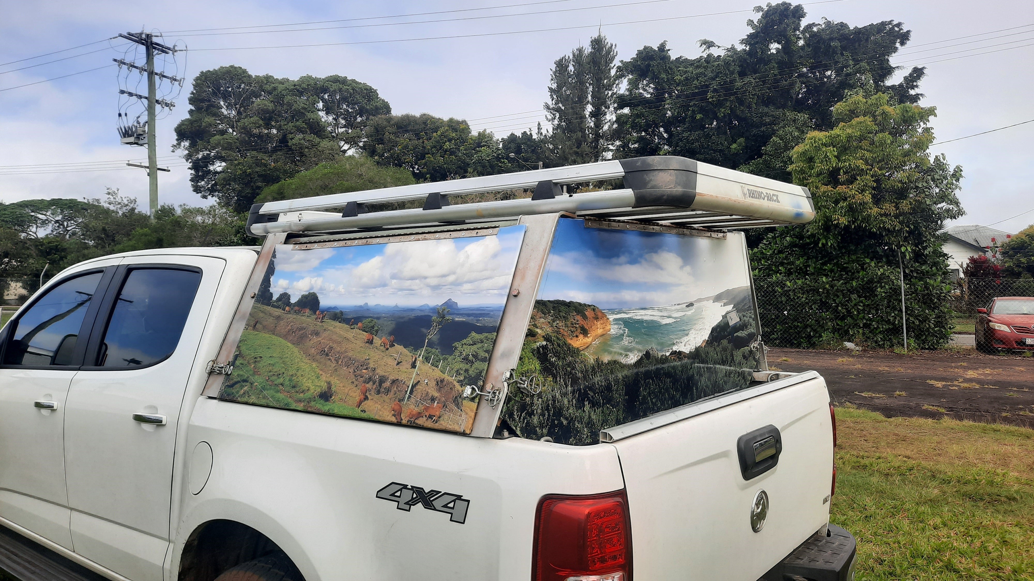 Mega Sticker Store custom vinyl wrap featuring a landscape photo on a white 4WD ute canopy for outdoor travel style.