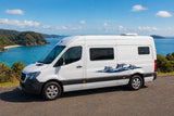 Mega Sticker Store dolphin and wave vinyl decal applied to the side of a white campervan overlooking the ocean.