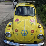 Mega Sticker Store yellow vintage car decorated with retro hippie flower and peace sign vinyl decals.
