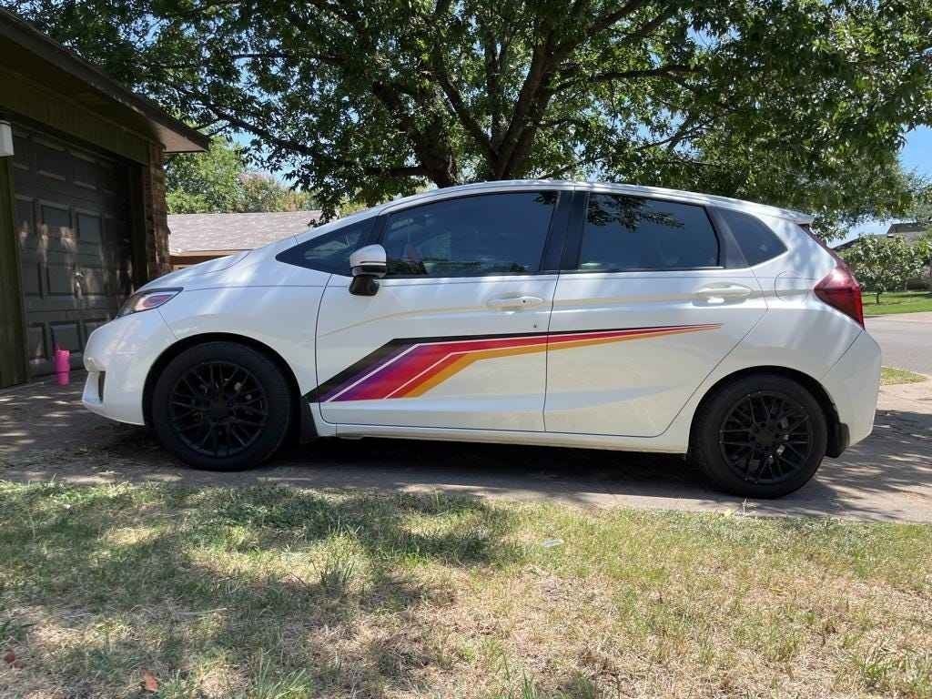 Mega Sticker Store universal racing stripe decal in colourful pinstripe design applied to the side of a white car