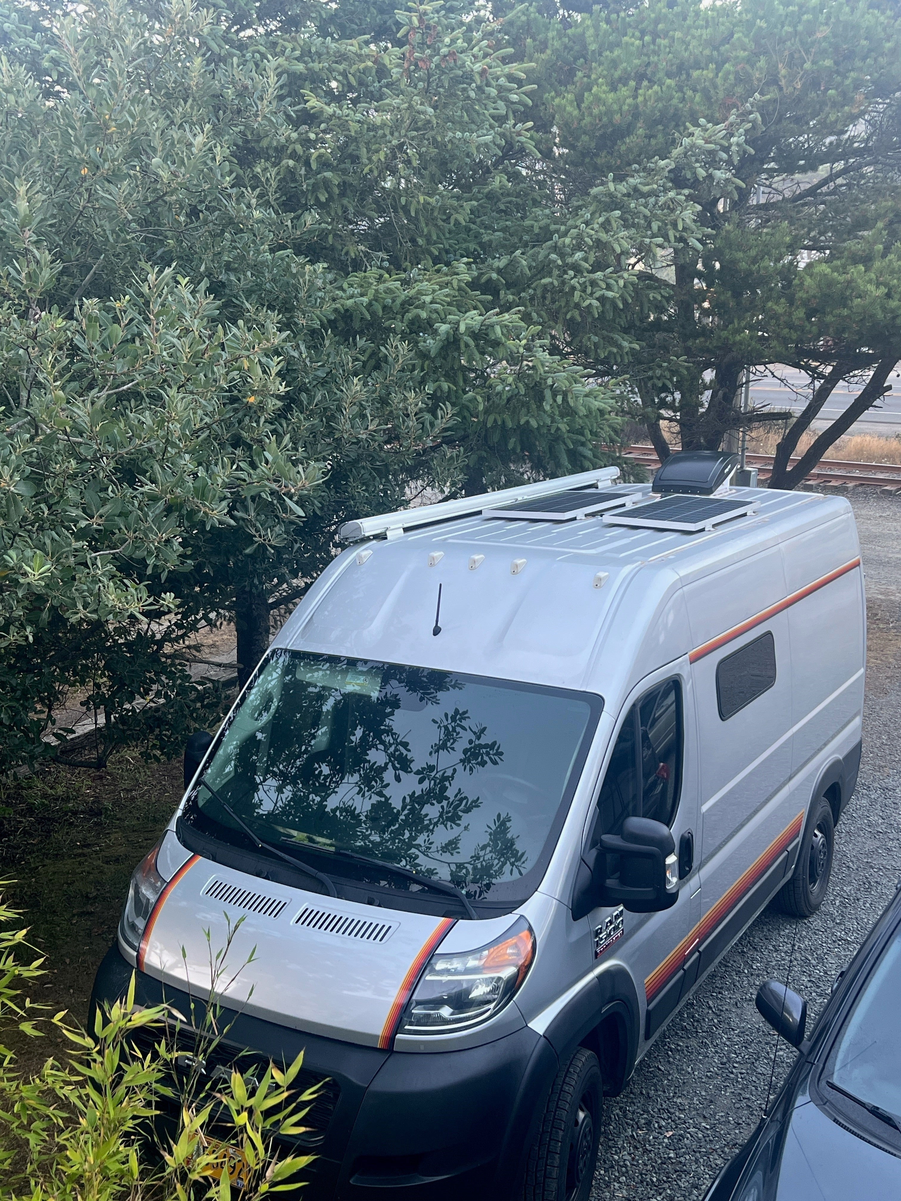 Mega Sticker Store retro orange and brown pinstripe decals applied to the side and hood of a silver camper van