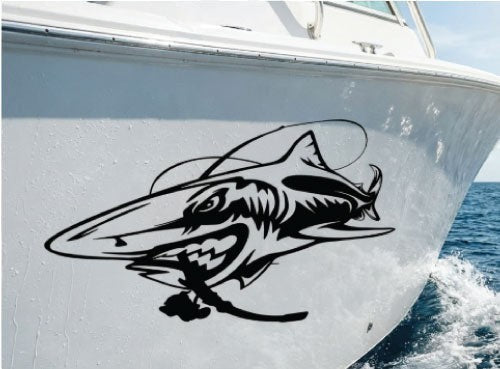 Mega Sticker Store large aggressive shark vinyl decal applied to the white hull of a fishing boat on the water.