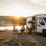 Mega Sticker Store Van Life Adventure vinyl sticker applied to a white campervan parked by a lake at sunset